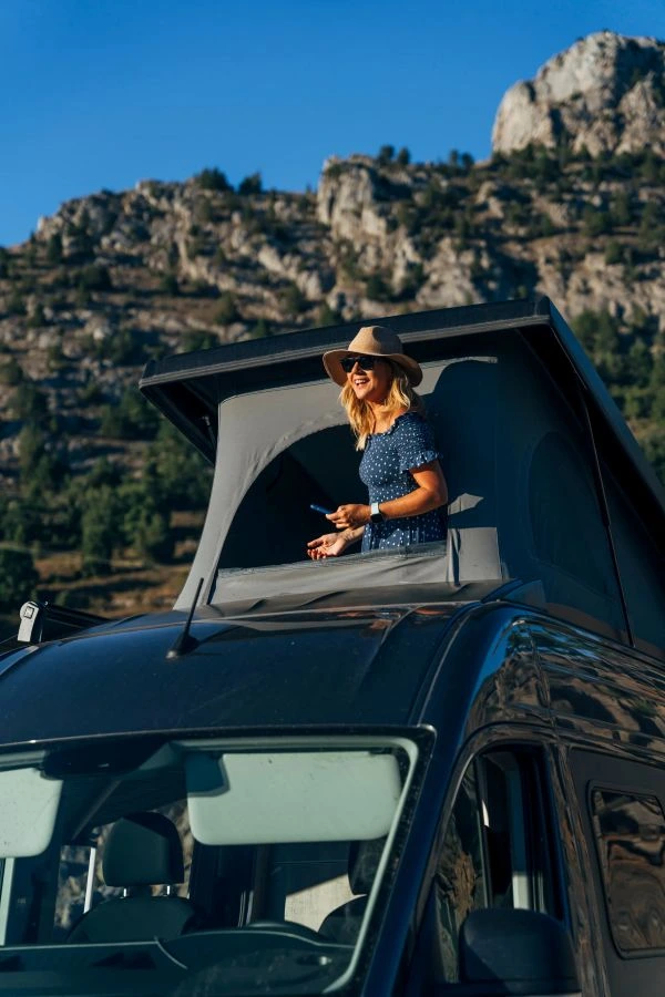 Woman in rooftop tent